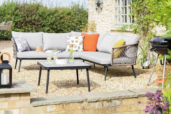 A 5-seater garden corner sofa set sitting outdoors.